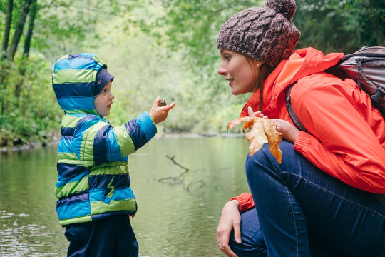 Mother and son exploring stream in forest, Vancouver, British Columbia, Canada