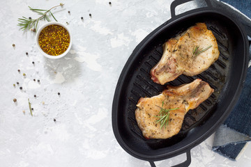 Meat grill. Pork on the bone in a cast-iron barbecue pan with ro