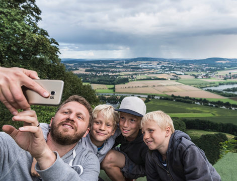 Father and sons taking selfie