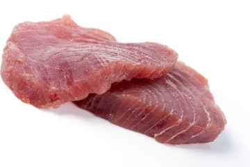 Fresh big raw fillet steak slices of Tuna for BBQ barbecue or Christmas Party on white background for gourmet or vegetarian Healthy low fat full of omega 3 acid dinner for people on diet after workout