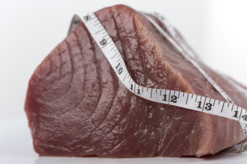 Fresh big raw fillet steak slices of Tuna for BBQ barbecue on white background for gourmet or...