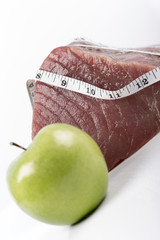 Fresh big raw fillet steak slices of Tuna with green apple for BBQ barbecue on white background for...