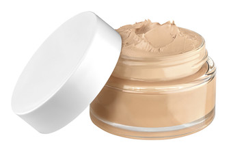 Nice glass face make-up creme foundation open container with a white plastic lid and smeared creme, isolated on white background, clipping path included