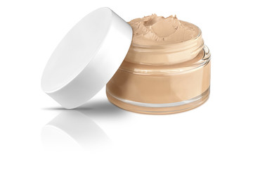Nice glass face make-up creme foundation open container with a white plastic lid and smeared creme, isolated on white background and with reflections and shadows, clipping path included