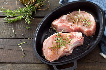 Raw meat. Raw pork on the bone in cast iron grill frying pan wit