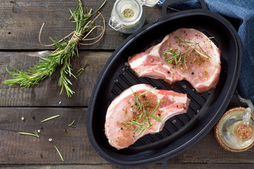 Raw meat. Raw pork on the bone in cast iron grill frying pan wit