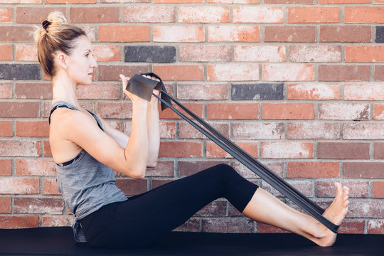 Side view of woman using resistance band