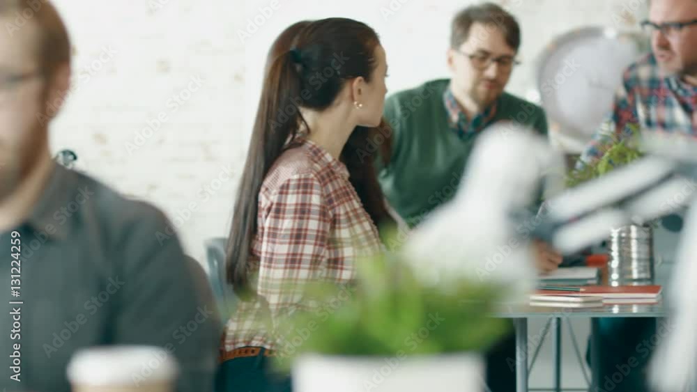 Poster camera moves from a close-up of a man working at his desktop computer to conference table where part