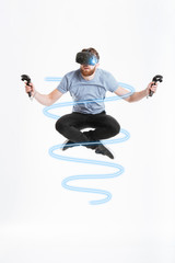 Young concentrated man wearing virtual reality device flying