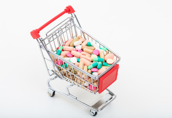 Trolley full of pills isolated on white background