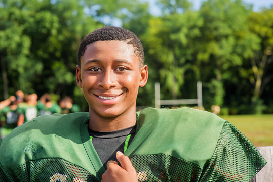 Portrait teenage male American football player at playing field