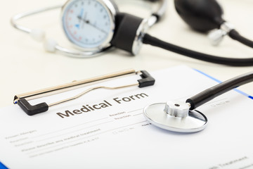 Medical form and a stethoscope on a desk