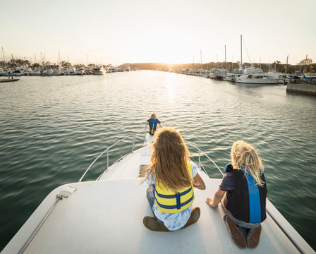 Rear view of children on bow of boat, Dana Point, California, USA