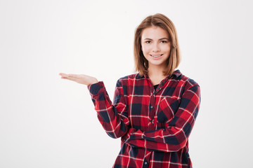 Smiling casual woman holding copyspace on the palm