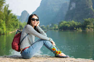 Girl sitting in the karst nature scenic area