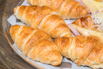 fresh croissants on wooden table
