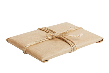 Gift parcel with kraft paper tied with twine isolated on white background. Angle view.