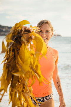 Portrait of woman holding seaweed