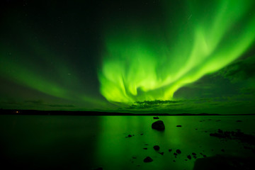 Lake on Fire - Strong aurora borealis fire up over a northern lake. Yellowknife, NWT, Canada.