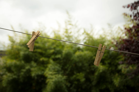 Wooden clothes pegs on washing line, close-up