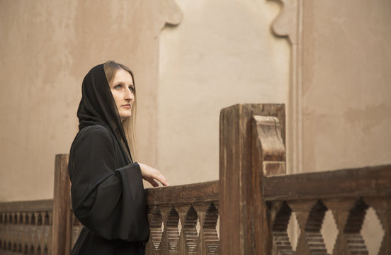 Woman In Traditional Dress Called Abaya In Jabreen Castle