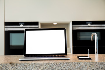 Laptop and phone on kitchen. Flat. Apartment. High definition photo.