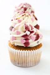 Valentine cupcakes decorated with sweet hearts isolated on white background.
