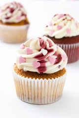 Valentine cupcakes decorated with sweet hearts isolated on white background.
