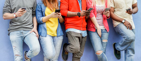 Group of multiracial students watching smart mobile phones