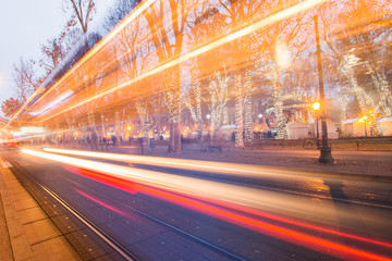     Tram passing Zrinjevac park in Zagreb Croatia during Advent, blue light trail, motion blur 