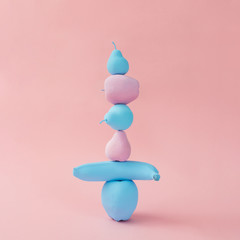 Stacked painted pink and blue fruits. Minimal concept.