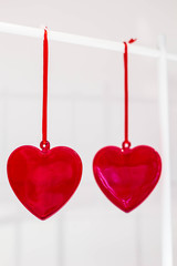 two red glass hearts hanging