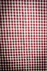 the checkered tablecloth on black stone background. Use for background.