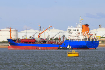 Fototapeta premium Cargo ship loading. Logistics and transportation with working crane bridge in harbor, logistic import export background and transport industry, Freight Transportation, Shipping, Nautical Vessel