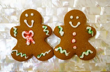 Two gingerbread men cookies decorated for Christmas