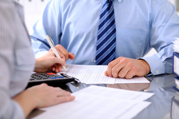 Bookkeepers or financial inspector making report, calculating or checking balance. Audit concept.