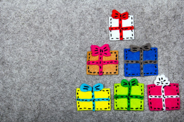 Obraz premium Christmas gifts on grey background. Felt Christmas ornaments with copy space