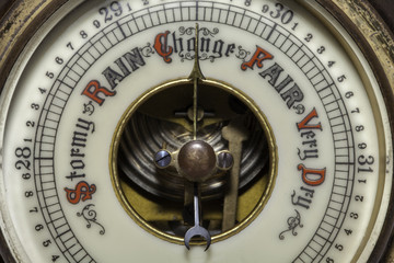 Climate Change symbolised by a vintage weather barometer forecasting change.