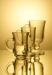 Three empty glasses set in rank in backlighting