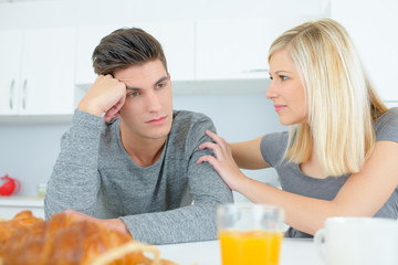 Woman consoling partner at breakfast table © auremar
