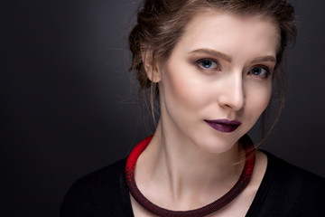 Portrait of a young girl with ornaments from beads.