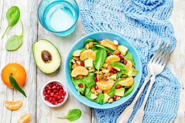 Spinach tangerines pomegranate avocado almonds walnuts salad