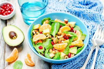 Spinach tangerines pomegranate avocado almonds walnuts salad