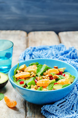 Spinach tangerines pomegranate avocado almonds walnuts salad