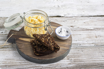 Egg salad cheese spread made toast and open sandwiches for a snack with green onions  bread roll. On  round cutting board supply. selective focus