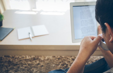 cup of coffee and Tablet with hand of business read news