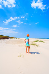 Young woman tourist standing in white sand on Debki beach, Baltic Sea, Poland