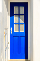 Blue door to typical white house in Naoussa village, Paros island, Greece