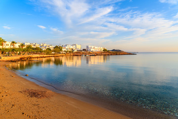Fototapeta premium A view of beach in Naoussa village at sunrise time, Paros island, Cyclades, Greece
