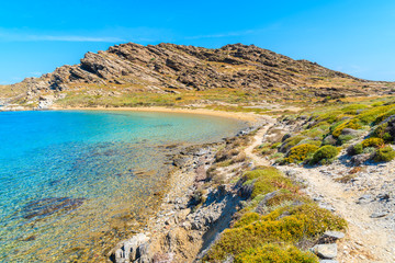 Beautiful coastal path along crystal clear sea water in Monastiri bay on Paros island, Greece